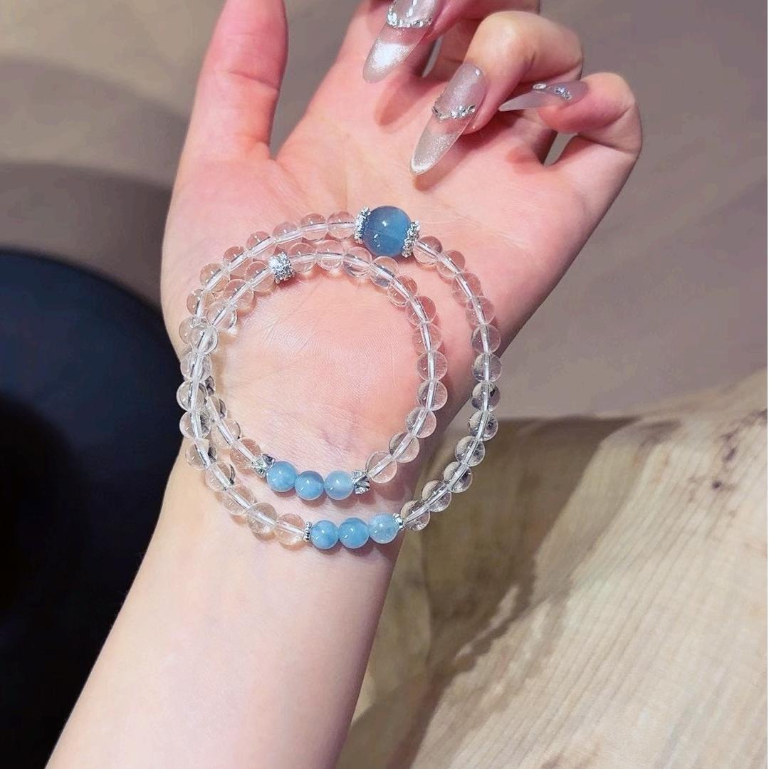 Multi-layer bracelet with clear quartz and aquamarine, designed to enhance healing, balance, and positive energy.
