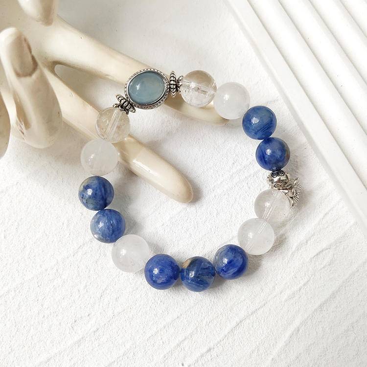 Clear quartz, blue crystal, and aquamarine multi-gemstone bracelet with alloy magic box, enhancing healing, positive energy, and balance.
