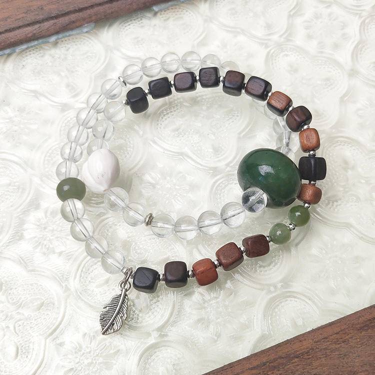 Clear quartz, jade, and agarwood double wrap bracelet supporting emotional balance, positive energy, and healing.
