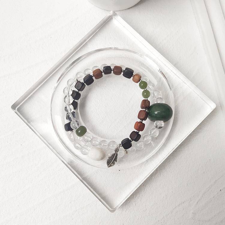 Healing bracelet featuring clear quartz, jade, and agarwood for energy, balance, and emotional well-being.
