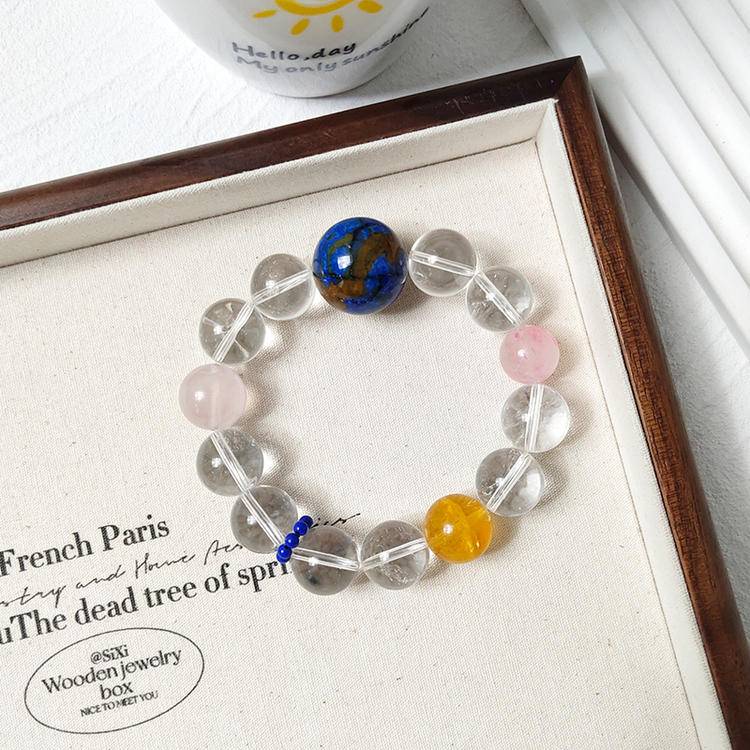 Multi-gem bracelet with clear quartz and various gemstones, designed to enhance healing, balance, and positive energy.
