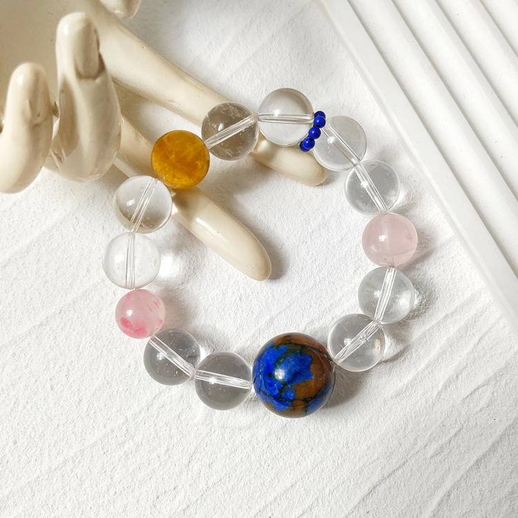 Clear quartz and multi-gemstone bracelet supporting emotional balance, positive energy, and healing.
