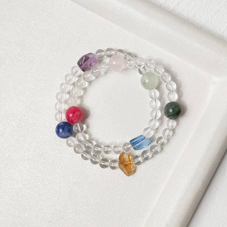 Clear quartz and multi-gemstone double-wrap bracelet supporting emotional balance, positive energy, and healing.
