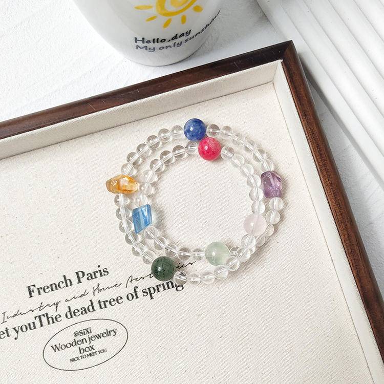 Clear quartz and multi-gemstone double-wrap bracelet promoting healing, balance, and positive energy.
