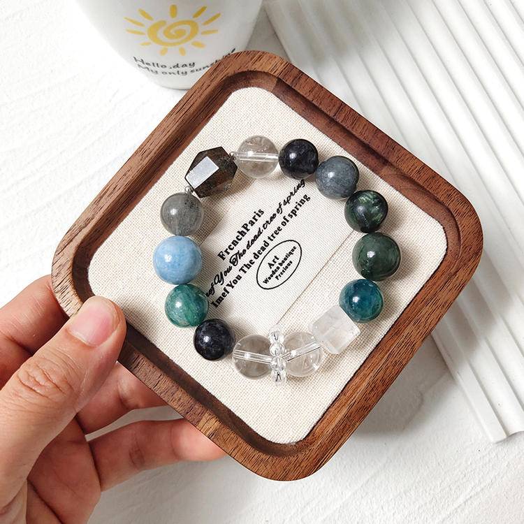 Dark green gemstone bracelet with green dragon quartz, green rutilated quartz, aquamarine, gray rabbit hair quartz, blue crystal stone, clear quartz, and black rutilated quartz, promoting positive energy, balance, and healing.
