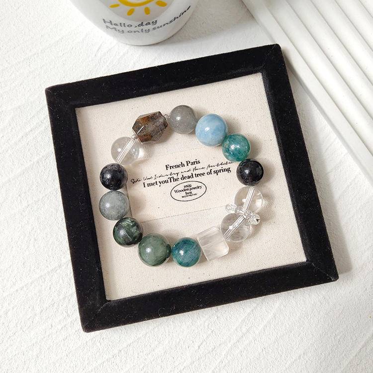 Dark green multi-gemstone bracelet including green dragon quartz, green rutilated quartz, aquamarine, gray rabbit hair quartz, blue crystal stone, clear quartz, and black rutilated quartz, designed to enhance healing, balance, and positive energy.

