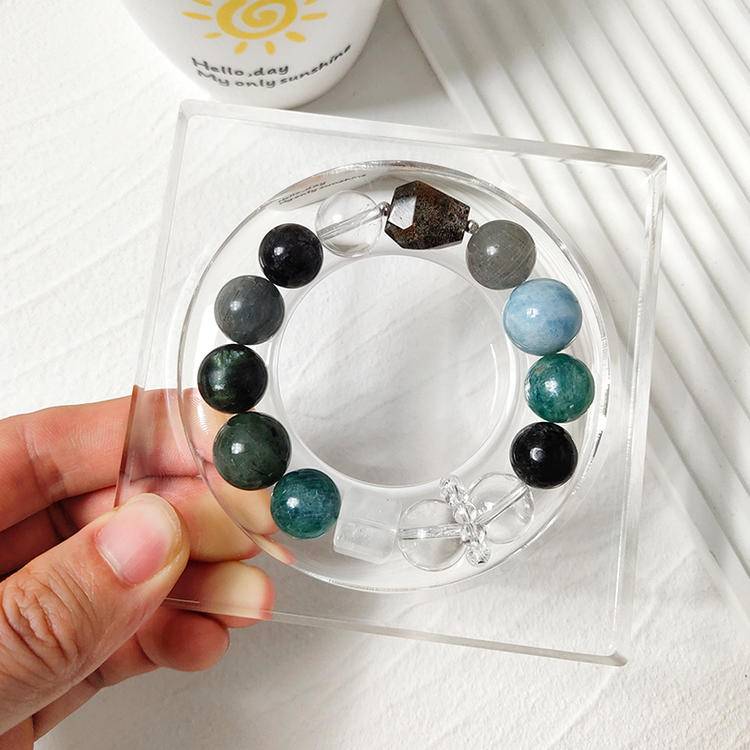 Healing bracelet featuring dark green multi-gemstones such as green dragon quartz, green rutilated quartz, aquamarine, gray rabbit hair quartz, blue crystal stone, clear quartz, and black rutilated quartz for emotional balance and energy.
