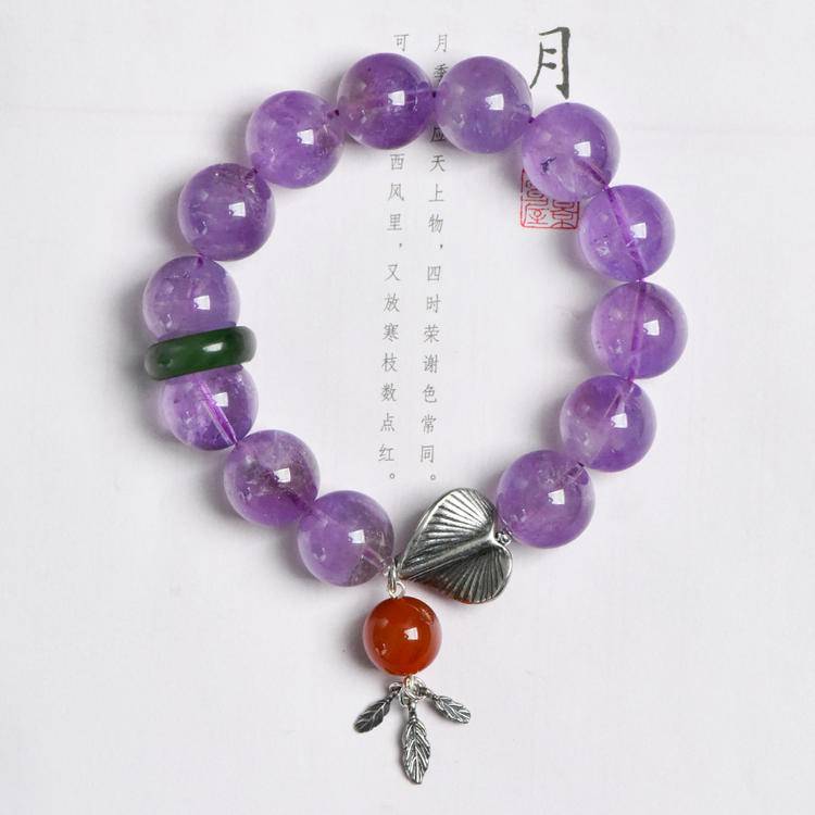 Healing bracelet featuring lavender amethyst, jade, and gingko leaf for energy, balance, and emotional well-being.
