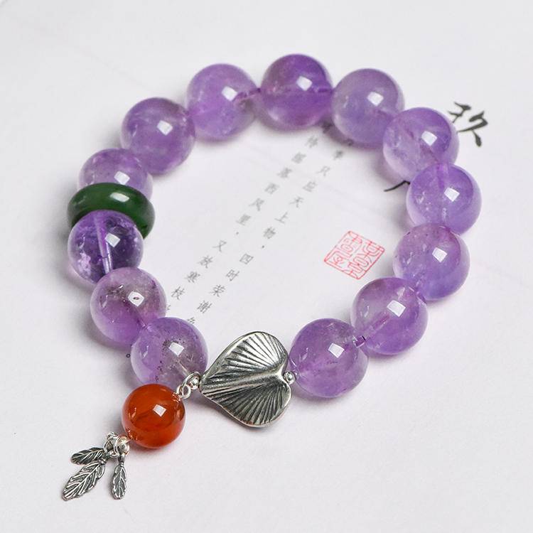Multi-gem bracelet with lavender amethyst, jade, and gingko leaf, designed to enhance healing, balance, and positive energy.
