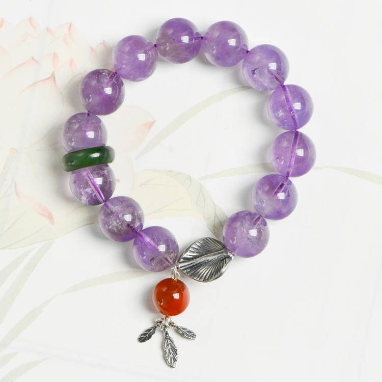 Lavender amethyst, jade, and gingko leaf bracelet supporting emotional balance, positive energy, and healing.
