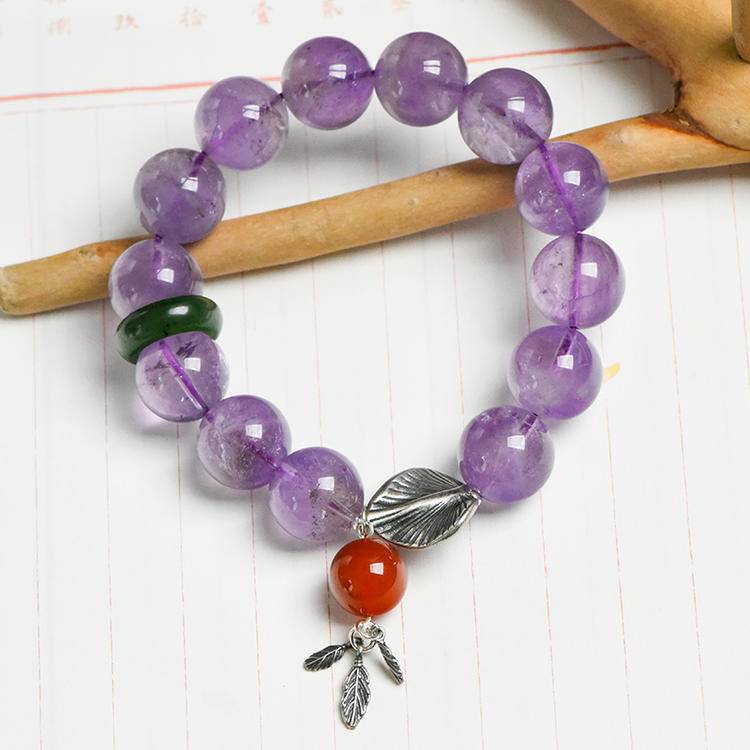 Healing multi-gemstone bracelet featuring lavender amethyst, jade, and gingko leaf for emotional well-being and energy balance.

