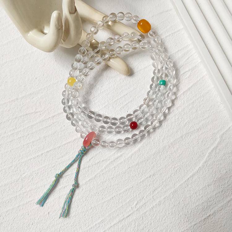 108-bead mala with nanhong agate, butterscotch amber, and clear quartz designed to promote meditation, mindfulness, and healing.
