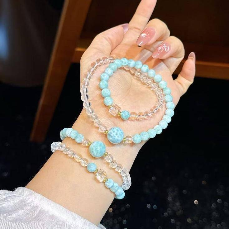 Healing gemstone bracelet with larimar and clear quartz promoting clarity and serenity.