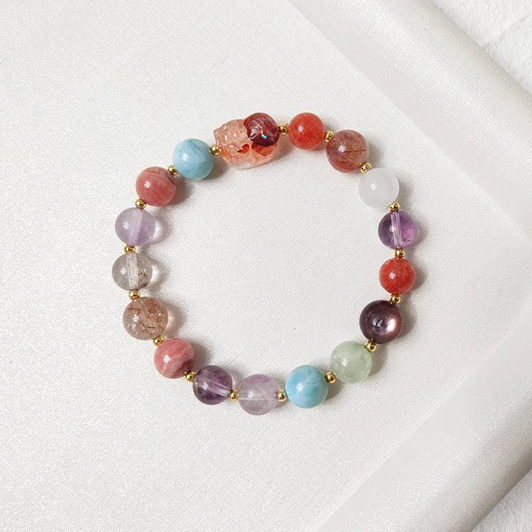 Healing multi-gemstone bracelet featuring red jade flower, pixiu charm, black gold crystal, amethyst, rhodonite, agate, clear phantom quartz, gold sunstone, lepidolite, and prehnite for emotional balance and protection.
