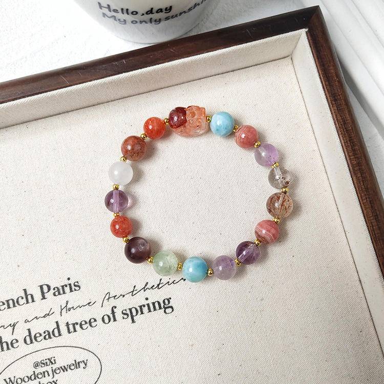 Red jade pixiu multi-gemstone bracelet with black gold crystal, amethyst, rhodonite, agate, clear phantom quartz, gold sunstone, lepidolite, and prehnite, promoting healing, protection, and positive energy.
