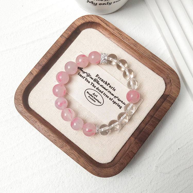 Healing multi-gemstone bracelet featuring rhodonite and clear quartz for emotional well-being and energy balance.
