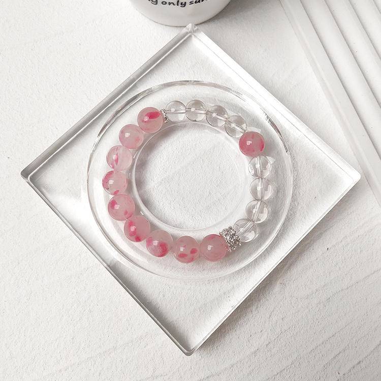 Healing bracelet featuring rhodonite and clear quartz for energy, balance, and emotional well-being.
