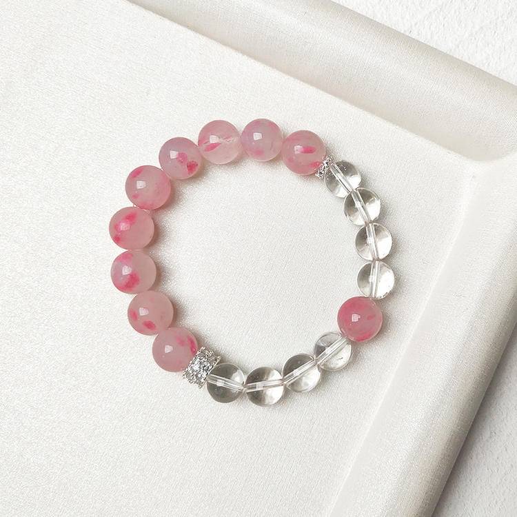 Multi-gem bracelet with rhodonite and clear quartz, designed to enhance healing, balance, and positive energy.
