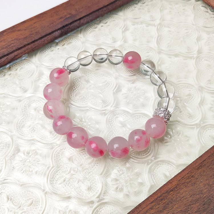 Rhodonite and clear quartz bracelet supporting emotional balance, positive energy, and healing.
