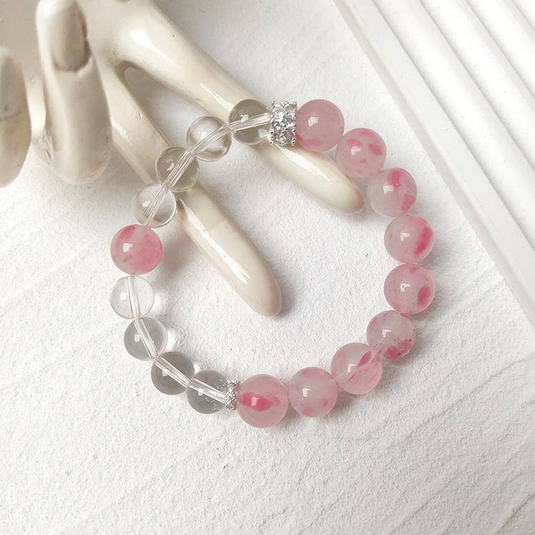Rhodonite and clear quartz multi-gemstone bracelet designed to promote healing, balance, and positive energy.
