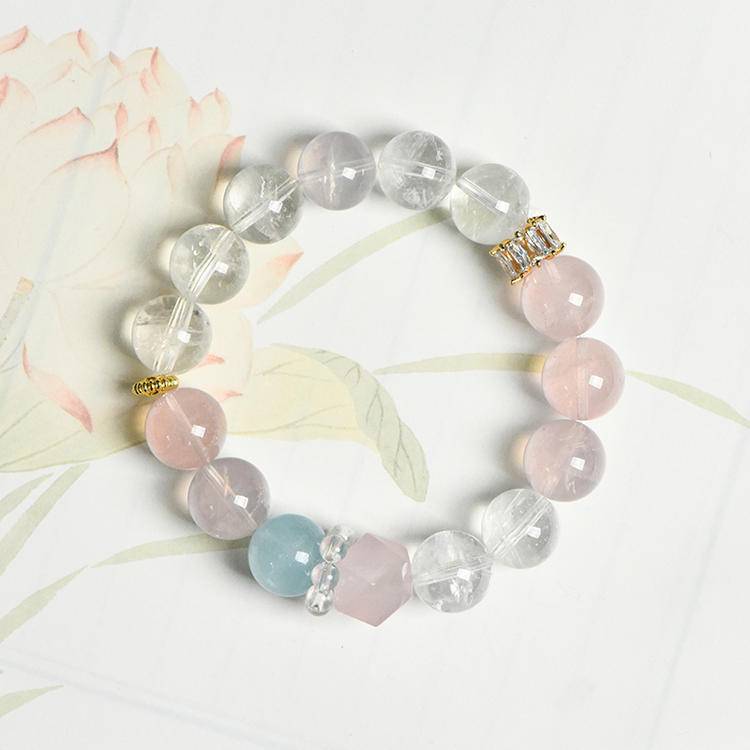 Healing multi-gem bracelet featuring rose quartz, aquamarine, and clear quartz for emotional well-being and energy balance.