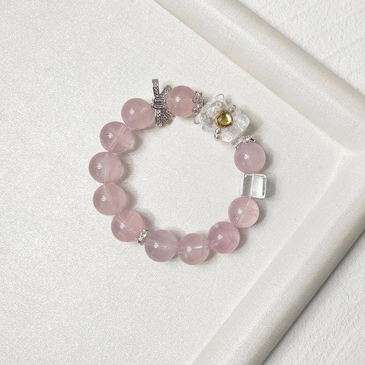 Healing bracelet featuring rose quartz bear charm for emotional well-being and energy balance.