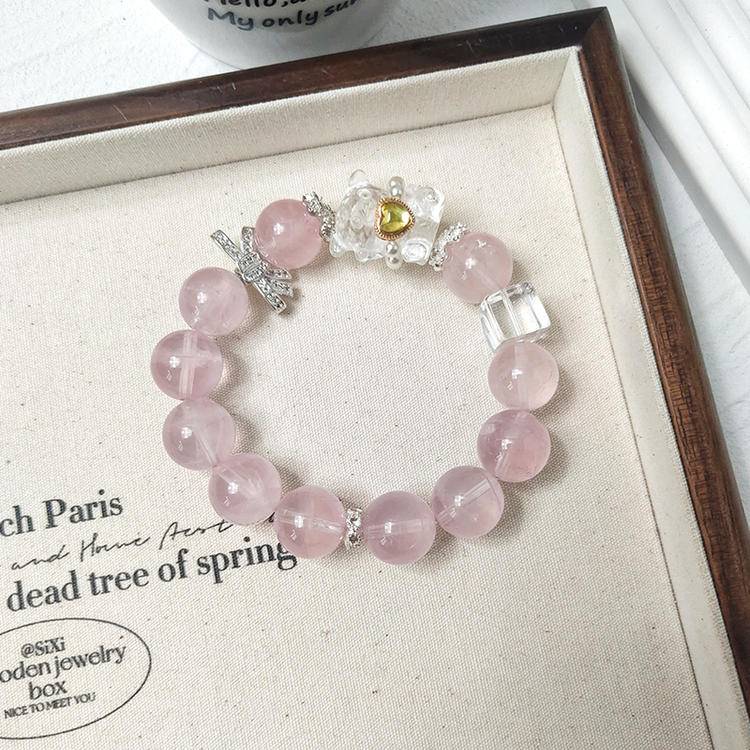 Multi-gem bracelet with rose quartz bear charm designed to enhance healing, balance, and positive energy.
