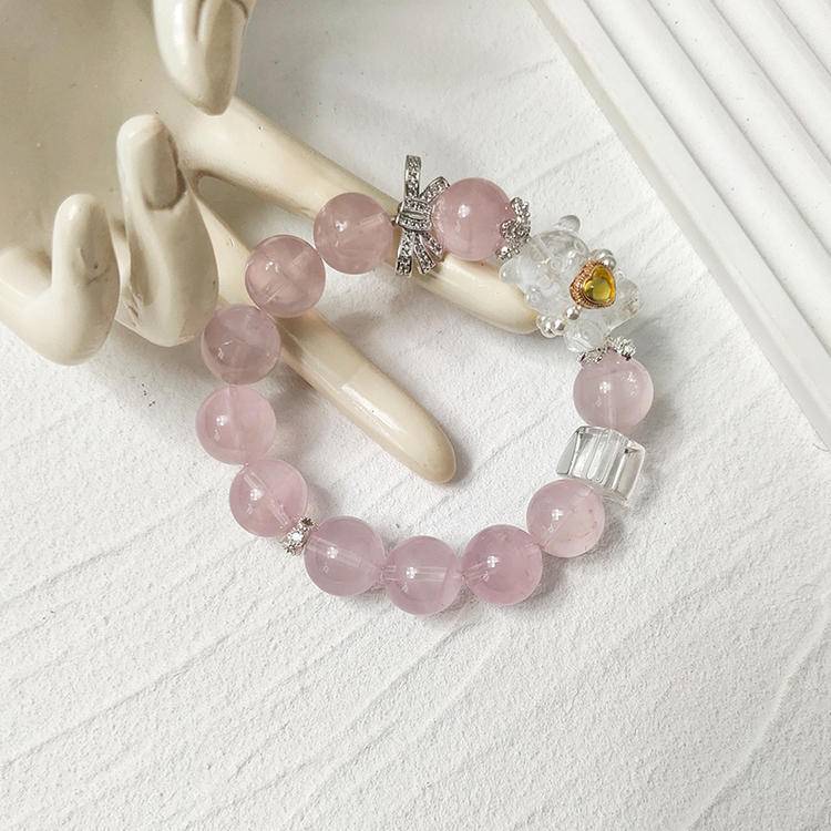 Healing bracelet featuring rose quartz bear charm for energy, balance, and emotional well-being.