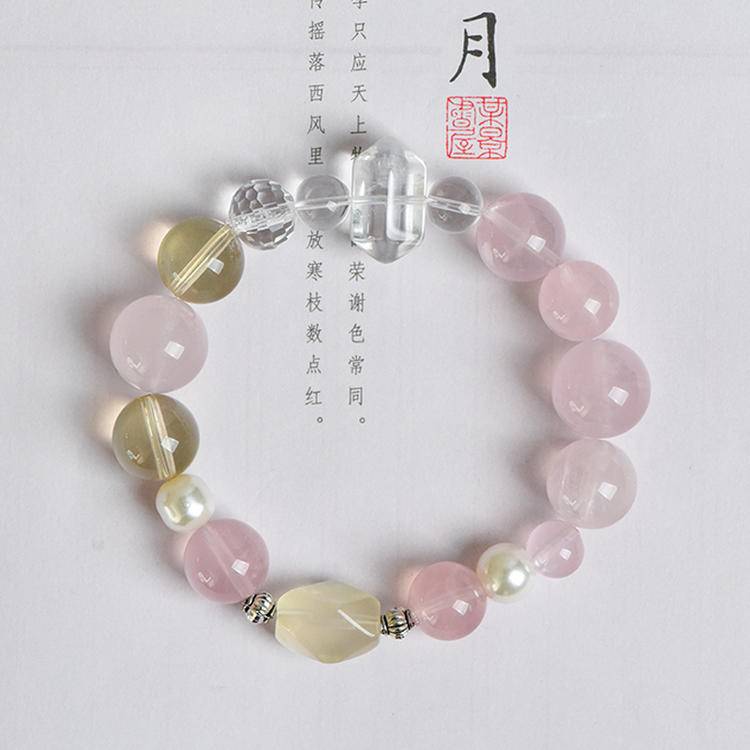 Rose quartz, citrine, and pearl bracelet supporting emotional balance, positive energy, and healing.