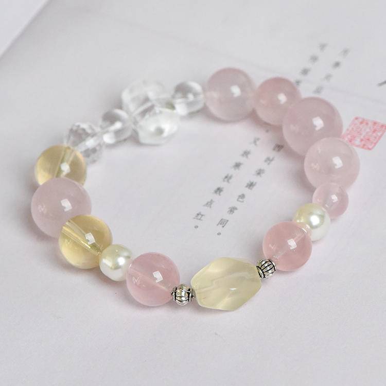 Healing bracelet featuring rose quartz, citrine, and pearl for energy, balance, and emotional well-being.