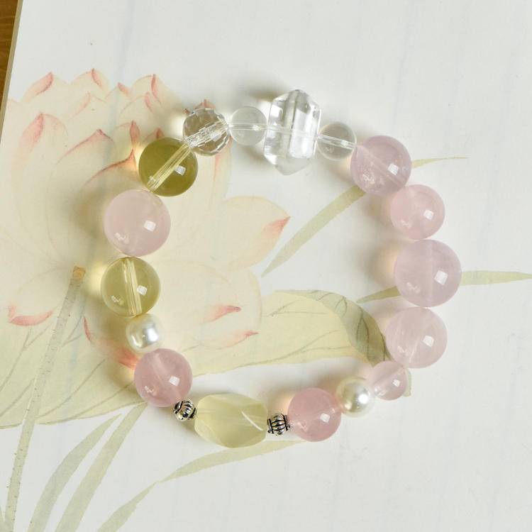Multi-gem bracelet with rose quartz, citrine, and pearl designed to enhance healing, balance, and positive energy.