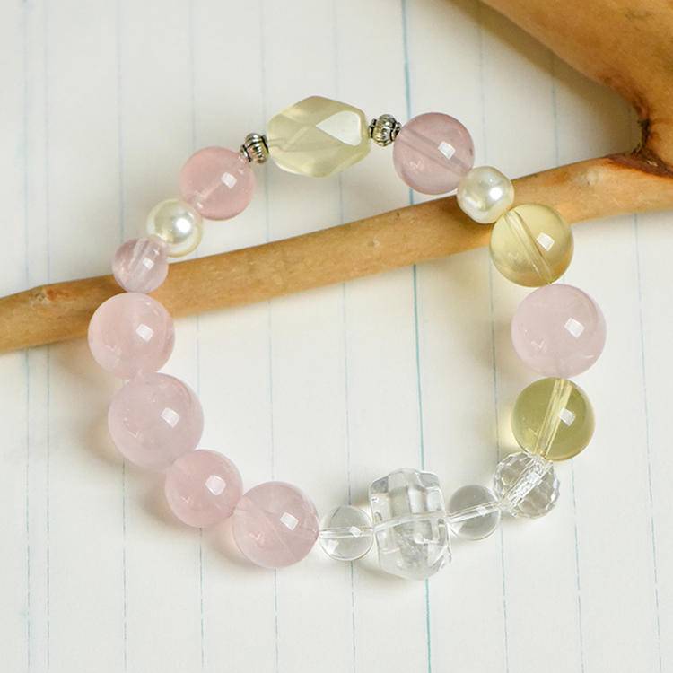 Healing multi-gem bracelet featuring rose quartz, citrine, and pearl for emotional well-being and energy balance.