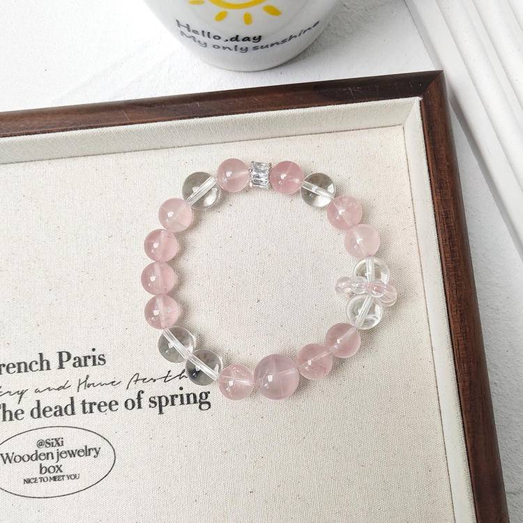 Healing multi-gemstone bracelet featuring rose quartz and clear quartz for emotional well-being and energy balance.
