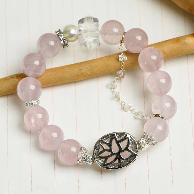 Multi-gem bracelet with rose quartz, clear quartz, and pearl designed to enhance healing, balance, and positive energy.