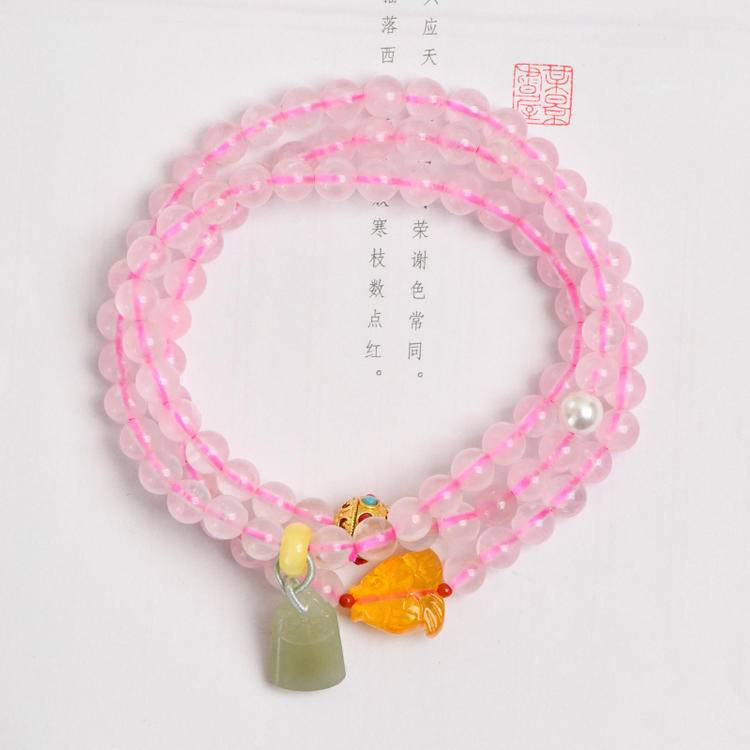 Healing triple-wrap bracelet featuring rose quartz and Hetian jade for energy, balance, and emotional well-being.