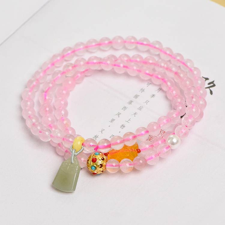 Healing triple-wrap bracelet featuring rose quartz and Hetian jade for emotional well-being and energy balance.