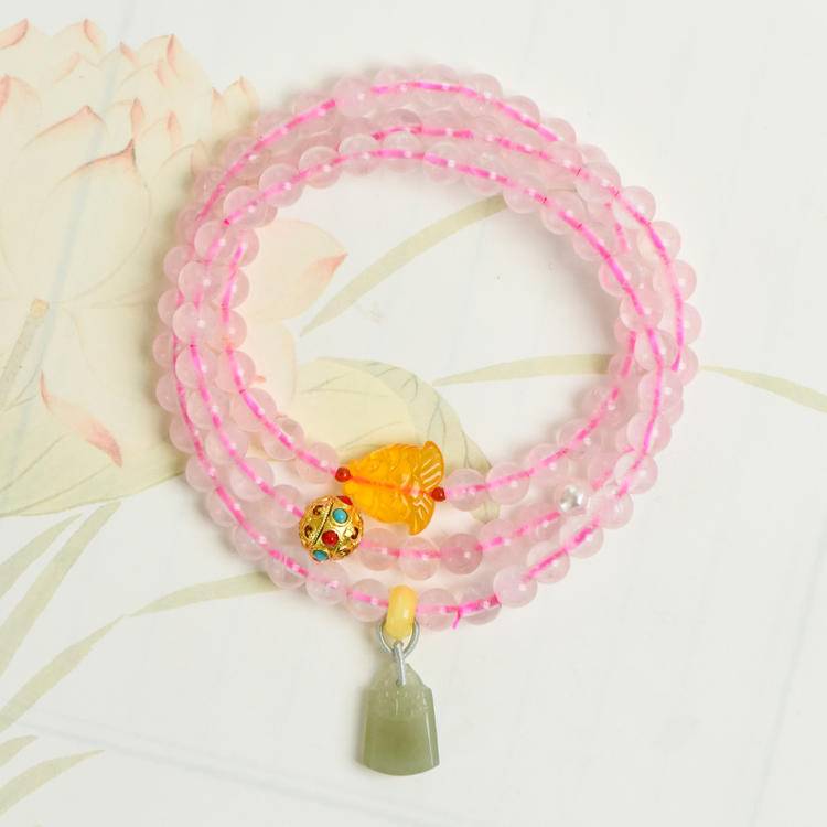 Healing triple-wrap bracelet featuring rose quartz and Hetian jade for emotional well-being and energy balance.