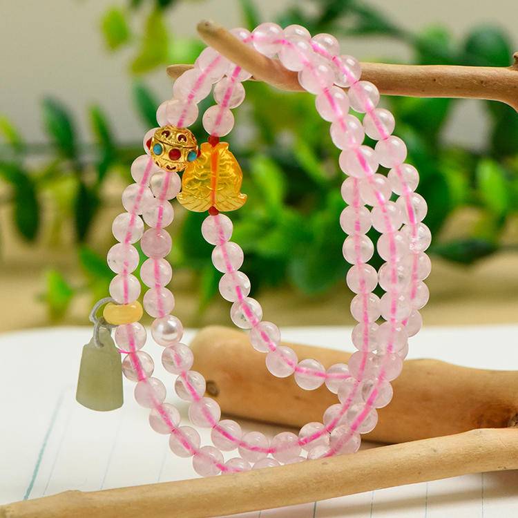Rose quartz and Hetian jade triple-wrap bracelet promoting healing, balance, and positive energy.