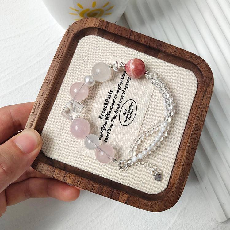Rose quartz, pearl, and rhodochrosite bracelet supporting emotional balance, positive energy, and healing.