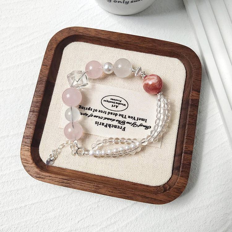 Multi-gem bracelet with rose quartz, pearl, and rhodochrosite designed to enhance healing, balance, and positive energy.
