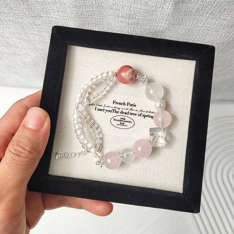 Healing multi-gem bracelet featuring rose quartz, pearl, and rhodochrosite for emotional well-being and energy balance.