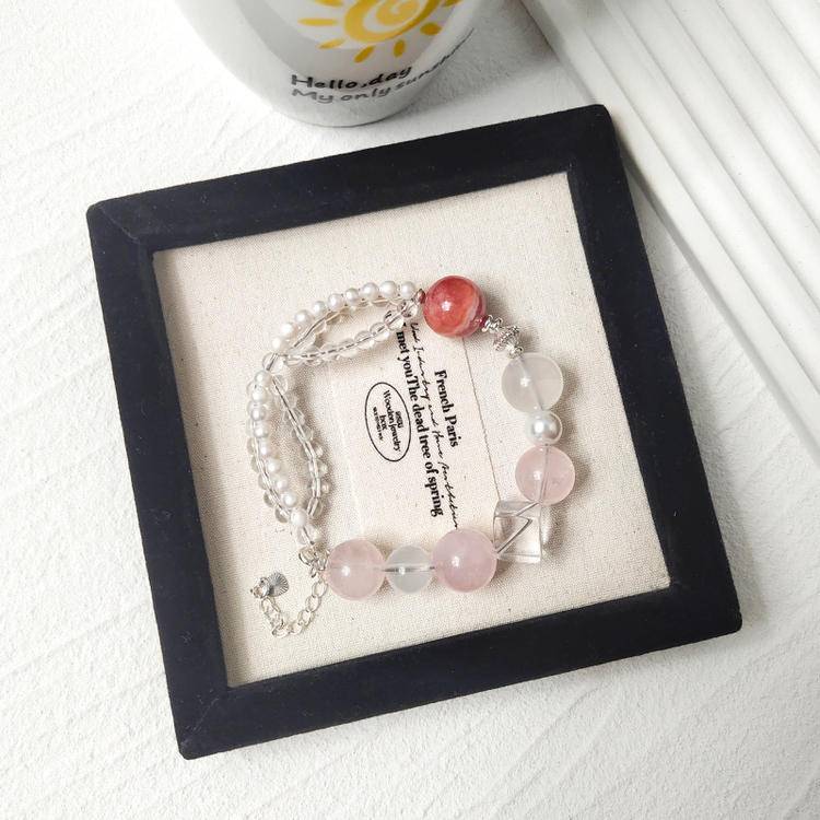 Healing bracelet featuring rose quartz, pearl, and rhodochrosite for energy, balance, and emotional well-being.