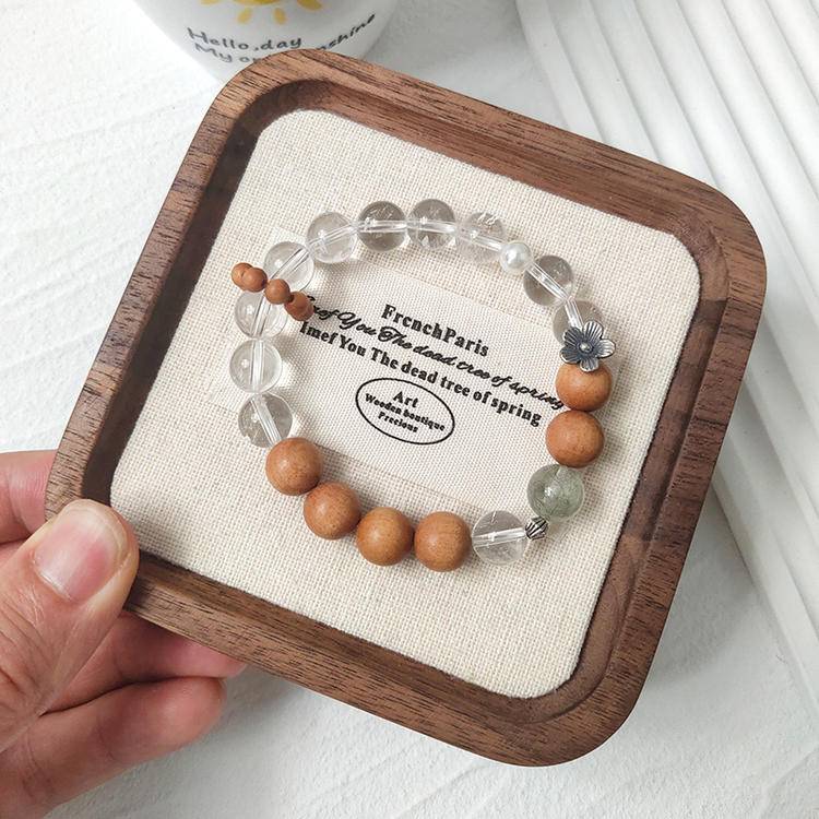 Sandalwood, green rutilated quartz, and clear quartz bracelet supporting emotional balance, positive energy, and healing.

