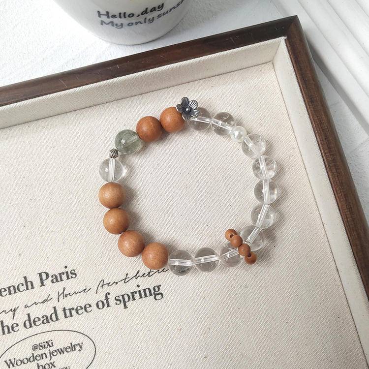 Sandalwood, green rutilated quartz, and clear quartz multi-gemstone bracelet promoting healing, balance, and positive energy.
