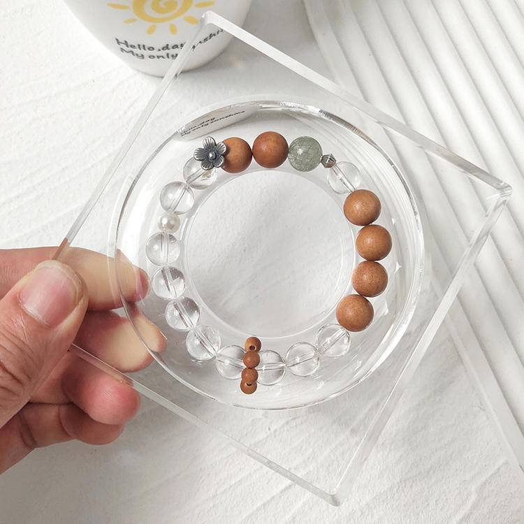 Healing bracelet featuring sandalwood, green rutilated quartz, and clear quartz for energy, balance, and emotional well-being.
