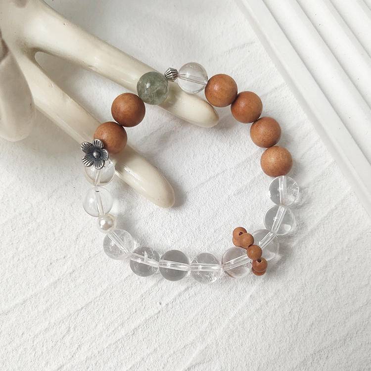Sandalwood, green rutilated quartz, and clear quartz multi-gemstone bracelet designed to promote healing, balance, and positive energy.
