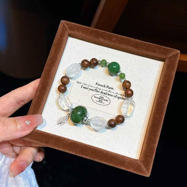Healing bracelet featuring sandalwood, jade, and clear quartz for energy, balance, and emotional well-being.
