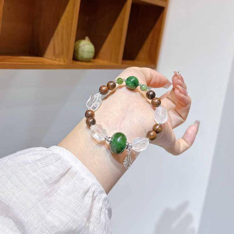 Multi-gem bracelet with sandalwood, jade, and clear quartz, designed to enhance healing, balance, and positive energy.
