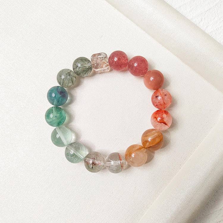 Healing bracelet with strawberry quartz, green gemstones, sunstone, black gold crystal, red and yellow jade flowers, designed for emotional balance and positive energy.
