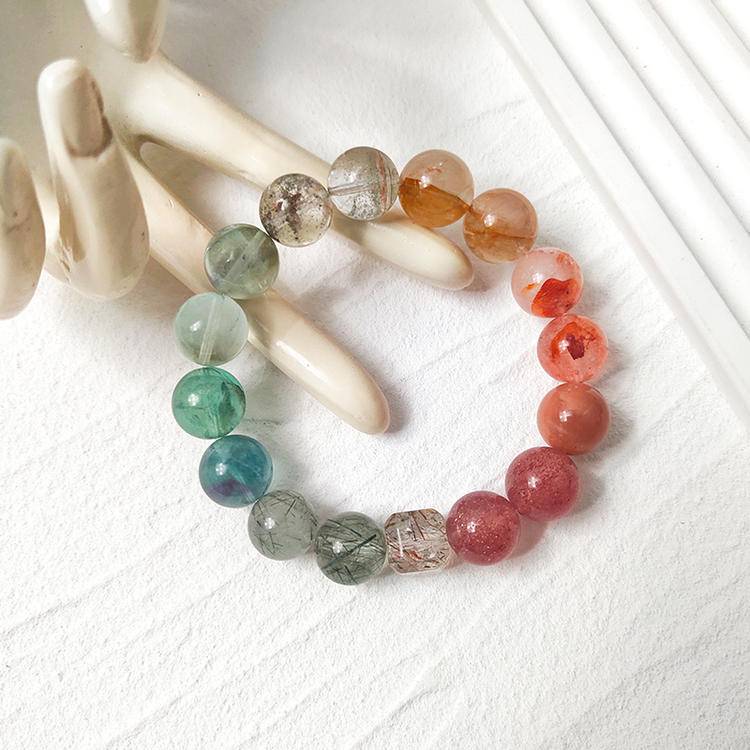 Strawberry quartz and green gem bracelet with sunstone, black gold crystal, fluorite, red and yellow jade flowers, promoting positive energy, balance, and healing.
